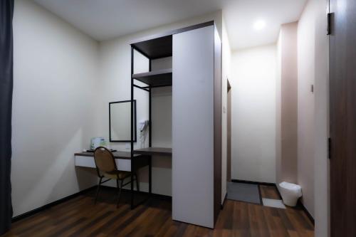 a room with a desk and a chair and a mirror at T Plus Hotel Bagan in Butterworth