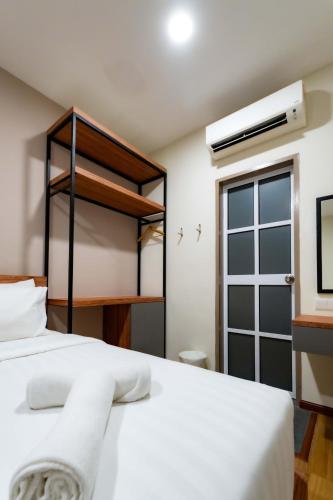 a bedroom with a large white bed and a window at T Plus Hotel Bagan in Butterworth