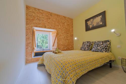 a bedroom with a bed and a window at La Maison Jopateliére in Mohon