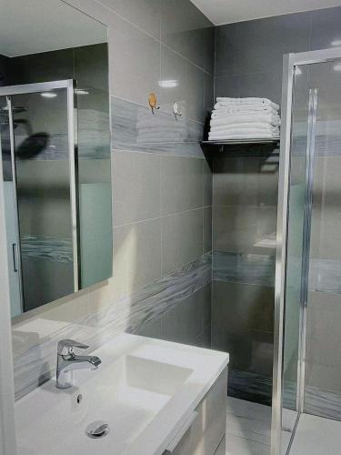 a bathroom with a sink and a shower and a mirror at ANMAN HHBB tourism & business rooms in Padova