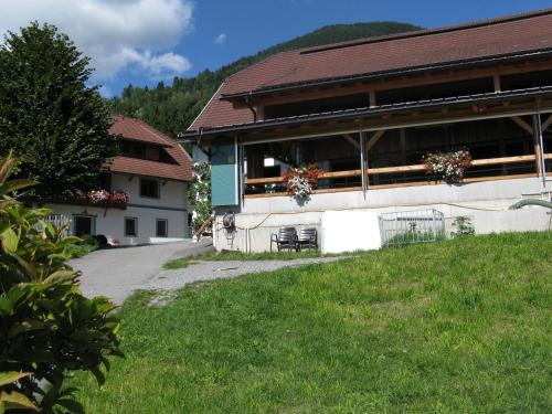 a building with a table and chairs outside of it at Ortnerhof in Millstatt