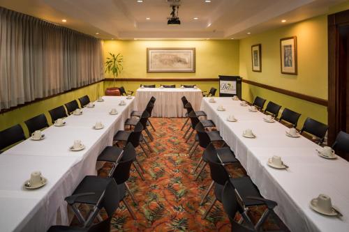 a conference room with long tables and chairs at Deja Resort All Inclusive in Montego Bay