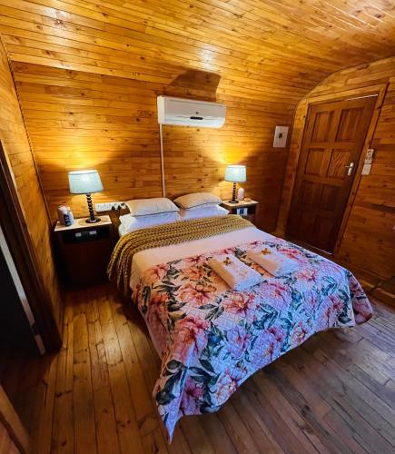a bedroom with a bed in a wooden cabin at Lake Cabin in Olifantshoek