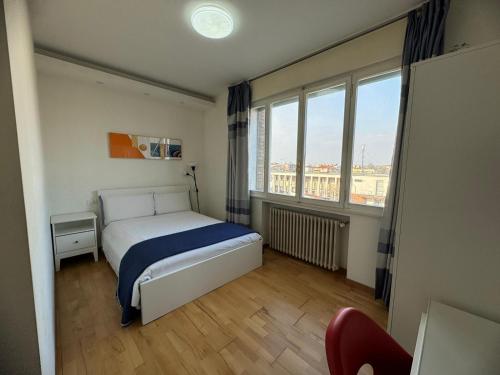 a bedroom with a bed and a large window at ANMAN HHBB tourism & business rooms in Padova