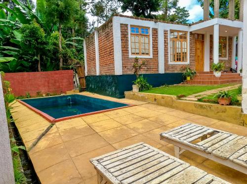 a backyard with a swimming pool and a house at Arusha Jua Eco Home- on coffee farm in Arusha