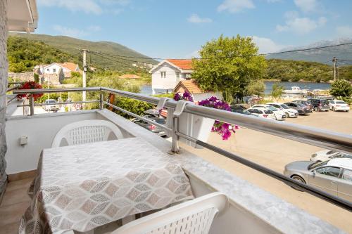 a balcony with a bed and a parking lot at Sunset Studio Apartments Bjelila in Tivat