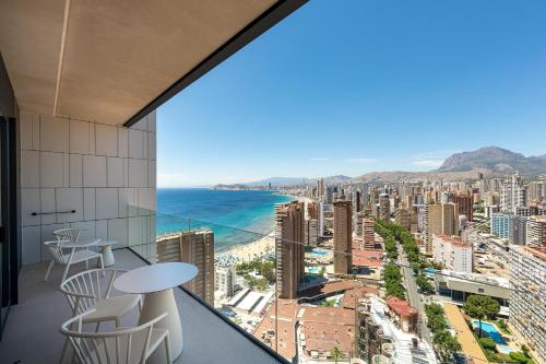 a room with a view of a city and the ocean at Port Benidorm Hotel & Spa 4* Sup in Benidorm