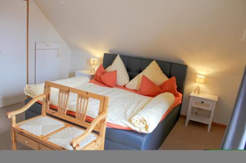 a bedroom with a blue bed with red pillows at Ferienwohnung Bubikat in Borkum
