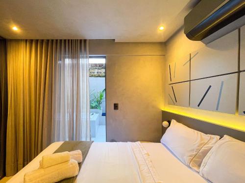a hotel room with a bed and a window at Way Bossa in João Pessoa