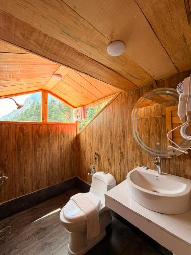 a wooden bathroom with a sink and a toilet at Azure Lagoon Resort in Ushu