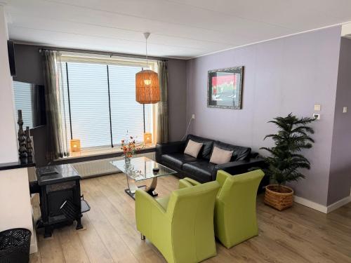 a living room with a couch and a table at Texelheerlijk 4 in De Koog