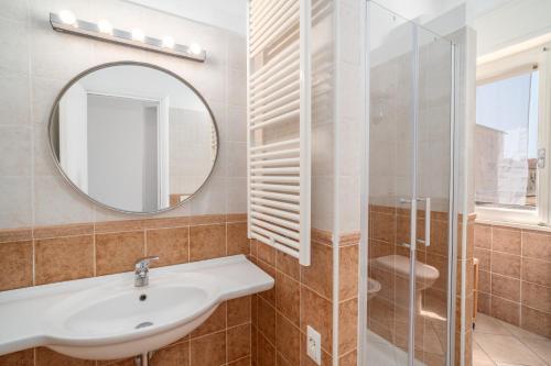 a bathroom with a sink and a mirror at Excelsior - Venturina Terme in Venturina Terme