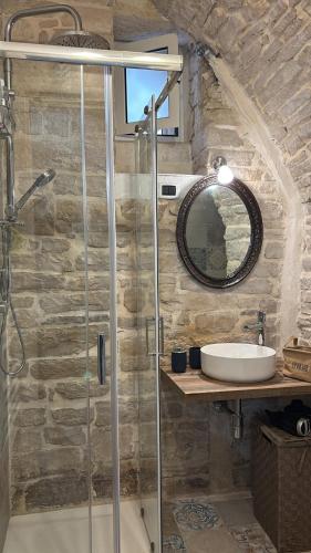 a bathroom with a glass shower and a sink at Appartamento San Giorgio in Bitonto