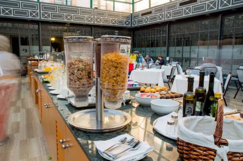 a buffet line with food and drinks and wine bottles at Palacio de los Velada in Avila