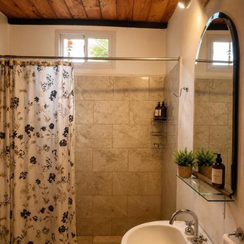 a bathroom with a shower and a sink at Cabañas Caranday in Capilla del Monte