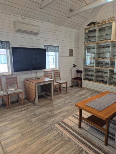 a large room with a flat screen tv and chairs at lillstugan in Avesta