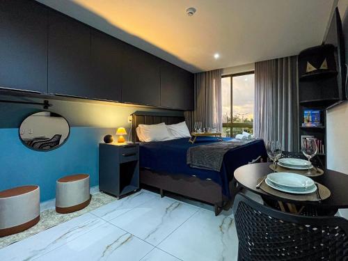 a hotel room with a bed and a table with plates on it at DVA Cabedelo by Hosppedar in Cabedelo