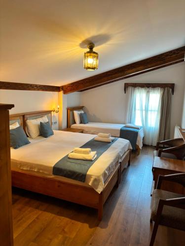 a bedroom with two beds and a chandelier at Duru Hanım Konağı in Bursa