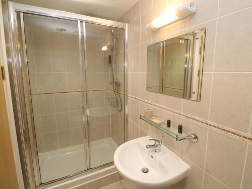 a bathroom with a shower and a sink at Ocean Seven in Newquay