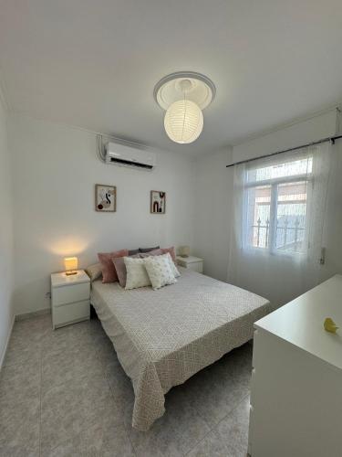 a white bedroom with a bed and a window at SotQui Cedeira in Cedeira