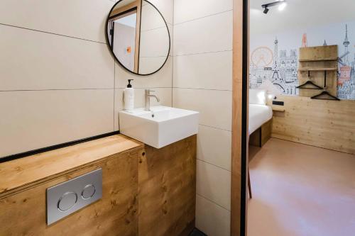 a bathroom with a sink and a mirror at easyHotel Alicante Centro in Alicante