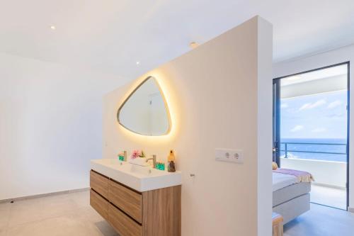 a bathroom with a sink and a window with the ocean at Villa Dushi Brisa 650 - Coral Estate in Willibrordus