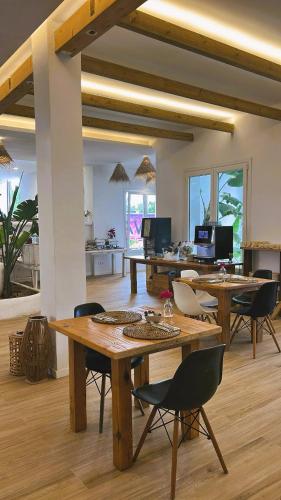 a living room with wooden tables and chairs at Wawa Tarifa in Tarifa