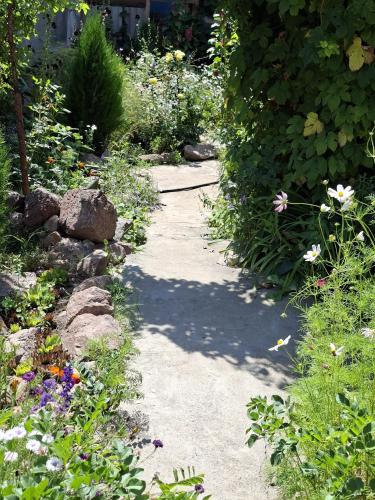 a garden path with flowers and plants at BOHO House in Cholpon-Ata