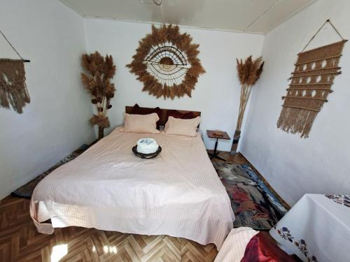 a bedroom with a bed with a bowl on it at BOHO House in Cholpon-Ata