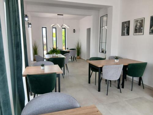 a dining room with tables and chairs and windows at Hollywood rooms in Sveti Petar