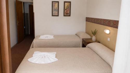 a room with two beds and a couch at Hotel Gran Lucerna in Valle Hermoso