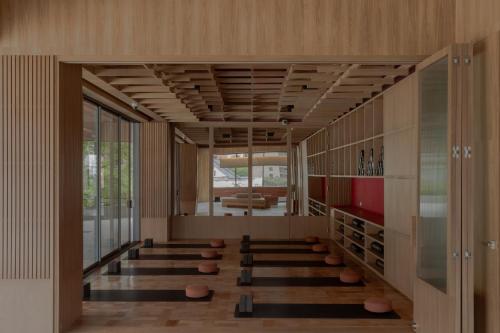 a room with a row of stools in a building at Wake Medellin, a Member of Design Hotels in Medellín