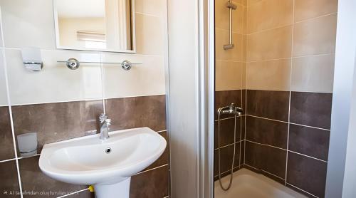 a bathroom with a sink and a shower at Villa Peri Luxury Pool Villa in Karşıyaka in Nicosia