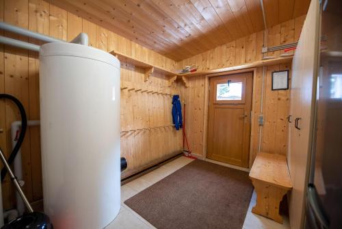 a room with a wood paneled wall and a door at Almhäuser Filzsteinalpe Almhaus 204 in Krimml
