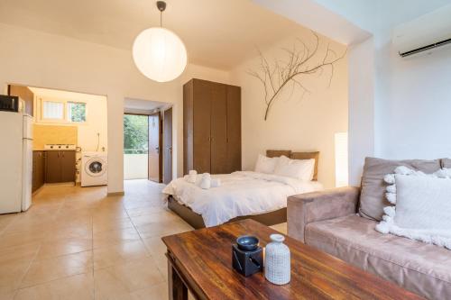 a living room with a bed and a couch at Green Emerald in Haifa