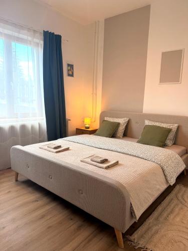 a large bed in a bedroom with a window at Apartments Chloe - Top 5 in Hollabrunn