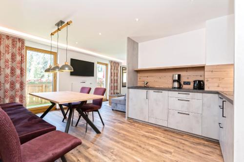 a kitchen and dining room with a table and chairs at Haus Alpenrose in Serfaus