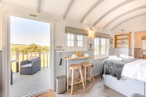 a bedroom with a bed and a balcony at 1 Bed in Beaworthy oc-93267 in Ashwater