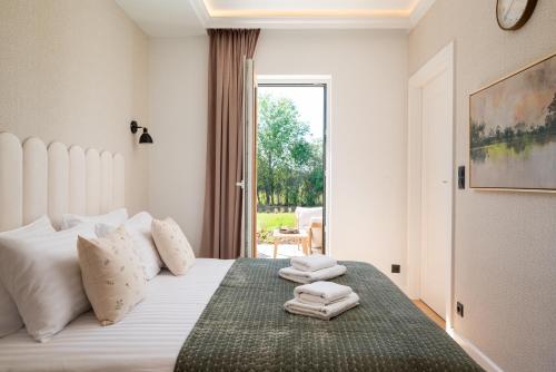 a bedroom with a bed with towels on it at Golf Park Rajszew in Rajszew