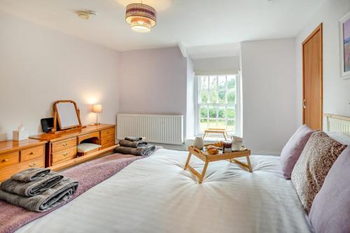 a bedroom with a bed with a table and a mirror at 2 Bed in Llangynidr oc-l31914 in Llangynidr