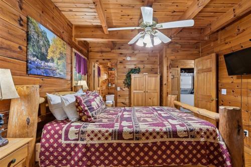 a bedroom with a bed and a ceiling fan at A Rustic Elegance #4 by Venture Smoky Mountains in Sevierville