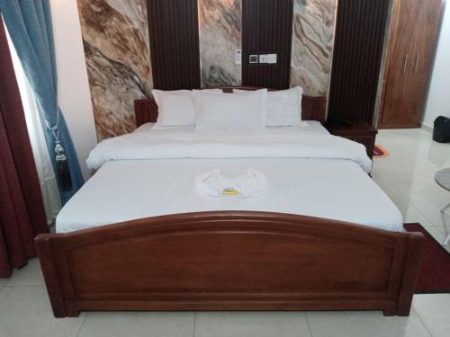ein Schlafzimmer mit zwei Betten mit weißer Bettwäsche in der Unterkunft Hotel Mandelson in Godomey
