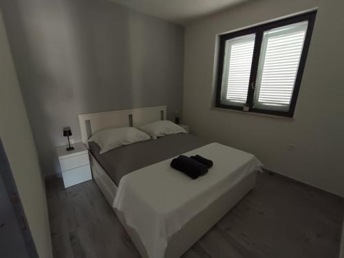 a bedroom with a bed with a black bag on it at La Diva Adriatica in Podstrana