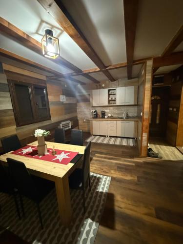 a kitchen and dining room with a wooden table at Kod Svastike in Džepare