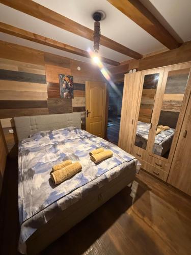 a bedroom with a bed with two yellow pillows on it at Kod Svastike in Džepare