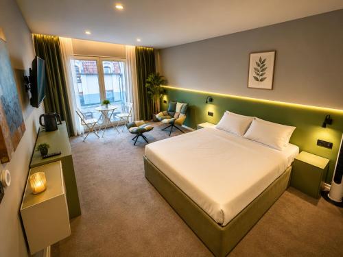 a bedroom with a bed and a living room at Boutique Hotel Bora in Peje