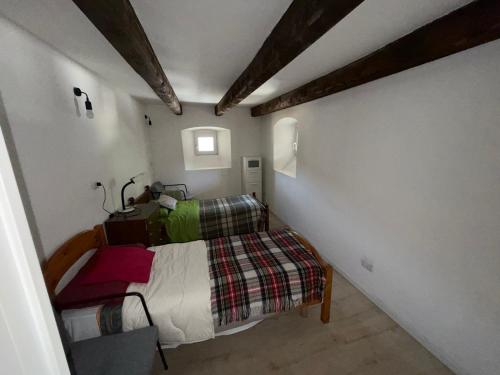a small bedroom with a bed in a room at Maison Jaune 26 in Aosta