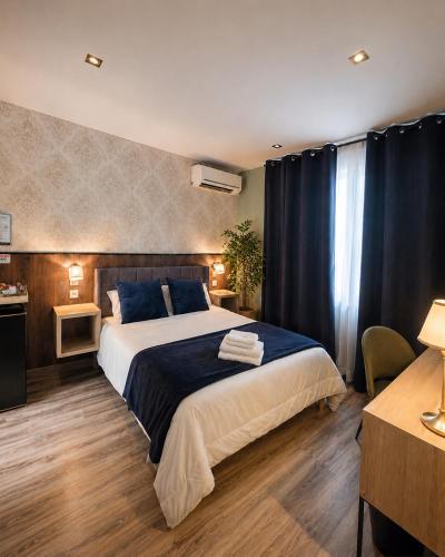 a bedroom with a large bed with blue pillows at Hostal Luxury Green Madrid Gran Vía in Madrid