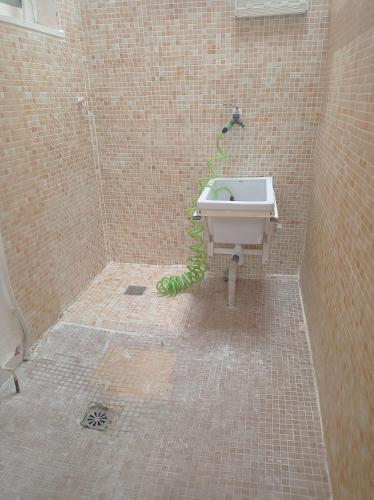 a bathroom with a sink and a green hose at villaislandia in Oropesa del Mar
