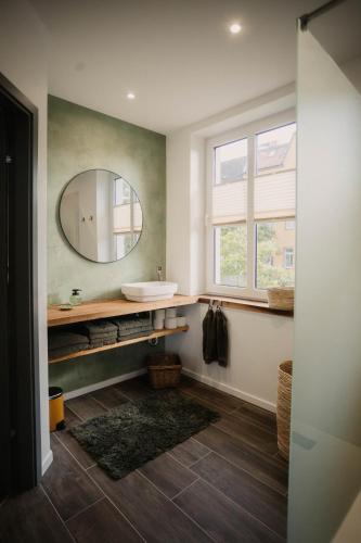 a bathroom with a sink and a mirror at Villa Medicus in Dessau